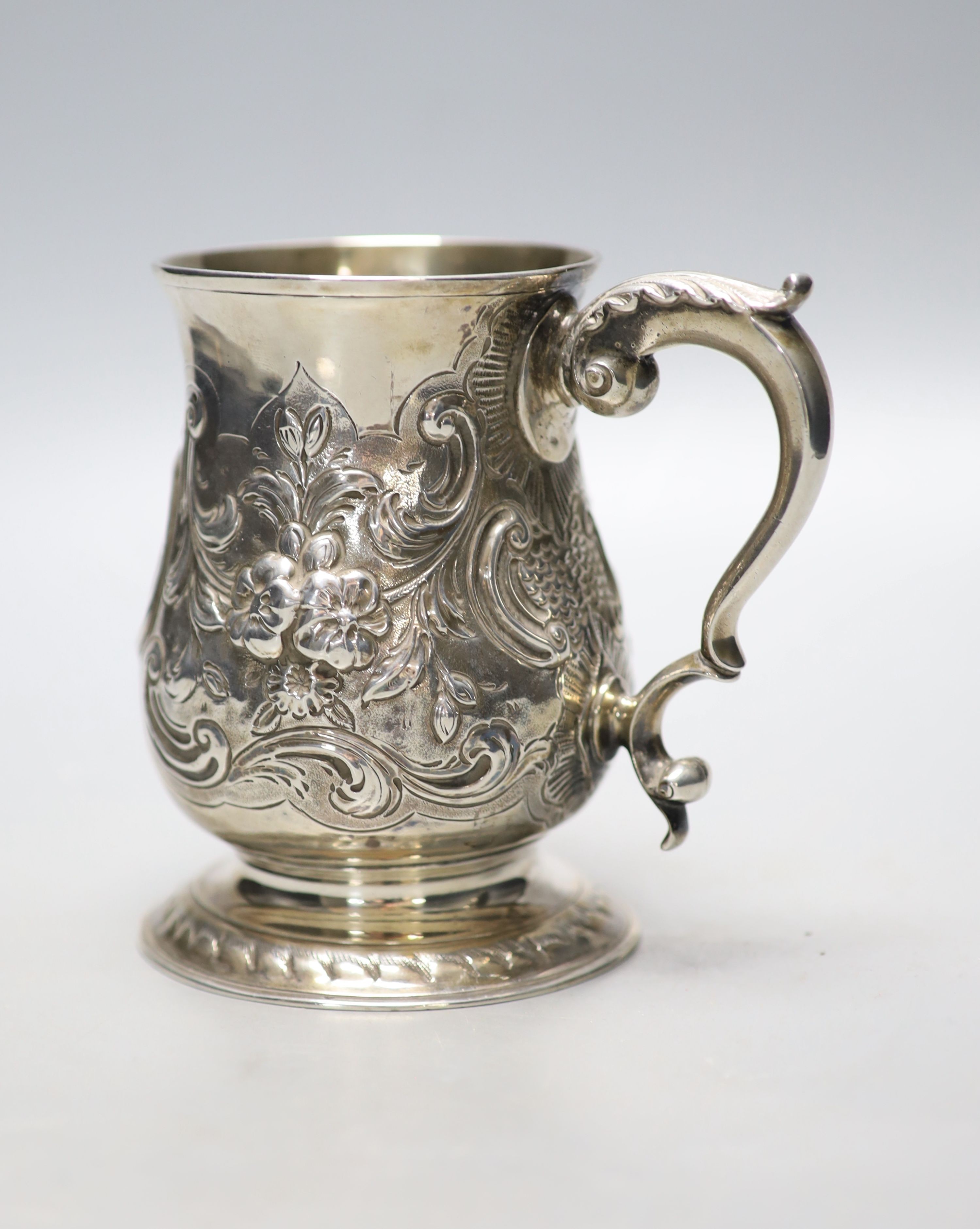 A George III silver baluster mug, with later embossed decoration and later engraved inscription, Langlands & Robertson, Newcastle, 1788, height 12.8cm, 11oz.